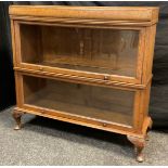 An early to mid 20th century oak bookcase, by Meovoto, (similar to Globe Wernicke), two tiers of