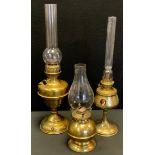 A 19th century, Art Nouveau brass oil lamp, by H Roninet, adorned with three portrait panels,