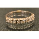 A diamond half eternity ring, set with nine round brilliant cut diamonds, total estimated diamond