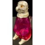 Novelty cranberry glass claret jug of a monkey sitting, mounted in silver plate