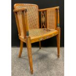 An Edwardian Sheraton Revival painted satinwood armchair, Bergere weave back, sides, and seat,