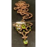 An Art Nouveau seed pearl and peridot pendant necklace, stamped 9ct, rolled gold clasp, 10.8g gross