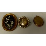 A Victorian mourning brooch, hair work and photographic revolving centre, unmarked yellow metal