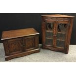 A Jaycee corner cabinet, carved frieze, glazed leaded pair of doors, enclosing two tiers of oak