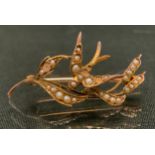 A seed pearl swallow sweet heart brooch, stamped 9ct 375, 2.6g gross (four pearls missing)