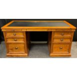 A stained pine partners’ pedestal desk, black faux-leather inset writing surface, draw-out