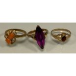 A 9ct gold garnet ring, 1.3g gross; others yellow metal, one indistinctly marked, 7.1g gross (3)