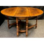 A Titchmarsh and Goodwin oak gate leg table, model RL8, 74cm high x 137cm wide (leaves open),