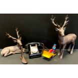 A Mid-century Bakelite telephone and metal toy tractor, decorative stags; etc