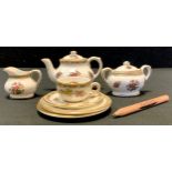 A Coalport Miniature Ming Rose pattern bachelor tea set, comprising teapot, sugar bowl, milk jug,