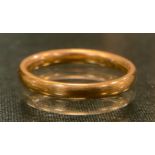A 22ct gold wedding band, size L/M, 3.6g