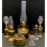 A French Lampe Olympe pigeon oil lamp; others made in Hong Kong, Octagonal, moulded glass; brass paw