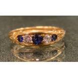 An 18ct gold diamond and sapphire ring, alternate set with three pale blue sapphire and two