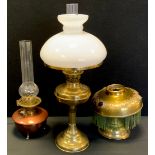 A Victorian copper and brass oil lamp; others brass, one with milk glass shade, 54cm high and