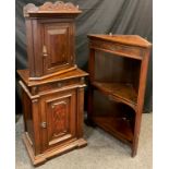 A French walnut bedside cabinet, over-sailing top, break-front, single drawer to frieze, above a