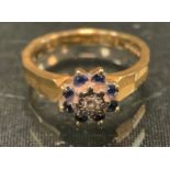 A diamond sapphire cluster ring, 18ct gold shank, size N, 5.2g gross.