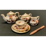 A Coalport Miniature Hong Kong pattern bachelor tea set, comprising teapot, sugar bowl, milk jug,