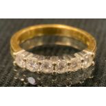 A diamond and 18ct gold six stone ring, each round brilliant cut stone approximately 0.09ct, size