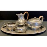 An Armada planished pewter three-piece tea set on oval tray, faux rivet design, comprising tea/