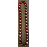 A Large faux cherry amber bead necklace, 43cm long