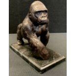 A Bronze coloured metal figure of a Gorilla, marble base, 20cm long