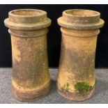 A pair of early 20th century terracotta chimney pots, each standing 63cm high, (2).