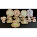 An early 20th century tea set for eight, decorated with underglaze green, with a floral print,