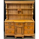 A Victorian Pine Dresser, plate-rack top with single small drawer and cubby-hole to centre, a