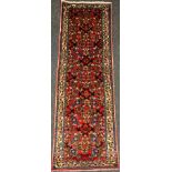 A North West Persian Rudbar runner carpet, knotted with a dense stylised floral field, in shades