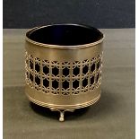 A silver and blue glass preserve pot, pierced collar, tripod feet, Birmingham 1912, 7.4ozt gross