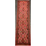 A North West Persian Malayer Runner carpet, knotted with stylised floral motifs in black, green,