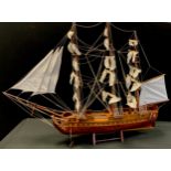 A wooden model of three masted sailing ship, 70cm high, 93cm long