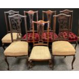 A Set of four Victorian Art Nouveau style walnut dining chairs, serpentine top rail, fretwork splat,