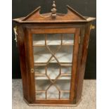 A Reproduction George III style corner cabinet, wall-mounted, astral-glazed door enclosing three