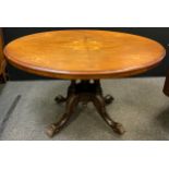 A Victorian inlaid walnut Loo table, oval top, with tilting mechanism to pedestal base, carved