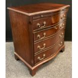 A reproduction mahogany serpentine-front chest cabinet, brushing slide to top, above a single