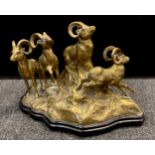 A mid 20th century brass sculpture as four Mountain Goats on Rocky Outcrop, wooden plinth base, 27cm