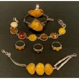 A Copal amber/amber coloured resin seven panel bracelet, bangle, four dress rings, part stamped PZ