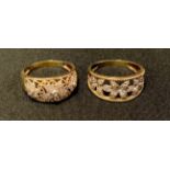 A 9ct gold diamond accented dress ring, open cast floral crest, sizz T; another similar size U, both