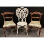 An ornate woven wicker chair, 103cm high; and a pair of Victorian carved mahogany side chairs, (3).