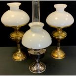 An early 20th century brass oil/paraffin lamp; others all with shades and chimneys (3)