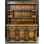 A Titchmarsh and Goodwin oak Dresser, with plate rack top, model RL 19855, 187cm high x 137cm wide x
