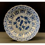 A Chinese porcelain blue and white shaped circular charger decorated with flowers and foliage,