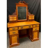 A Victorian mahogany and satinwood dressing table, Central mirror with architectural pediment,