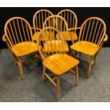 A set of six Ercol Blonde Elm dining chairs, spindle hoop-backs, comprising four chairs and pair