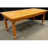 A large solid pine plank-top dining table, rounded rectangular top, turned legs, 76cm high x 182.5cm