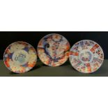 A Japanese Meiji period Imari plates, decorated with insects, serpent and flowers, 30cm diameter.