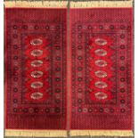 A pair of Middle Eastern Kashan style rugs, knotted with bokeh field, within margins of abstract