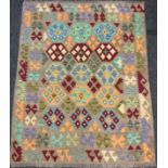 A Turkish Anatolian Kilim rug, knotted with a geometric pattern in blue, orange, and burgandy, on