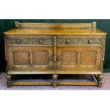 A mid 20th century carved oak sideboard, quarter galleried top, pair of carved drawers to frieze,